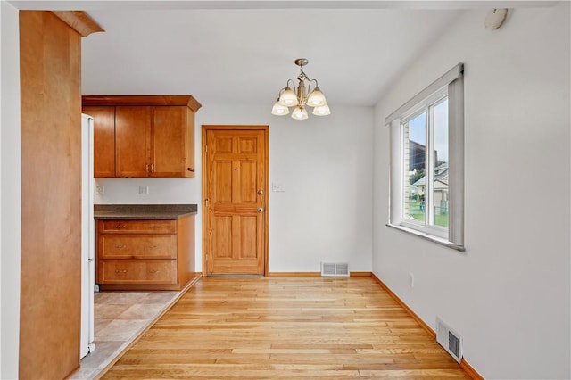 349 State Ave, Beaver, PA 15009 - unfurnished dining area featuring a chandelier, light wood finished floors, and baseboards