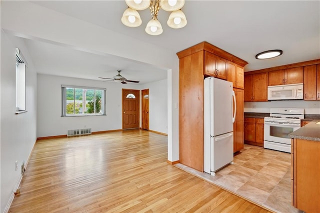 349 State Ave, Beaver, PA 15009 - kitchen featuring white appliances, brown cabinets, light wood-style flooring, and a chandelier