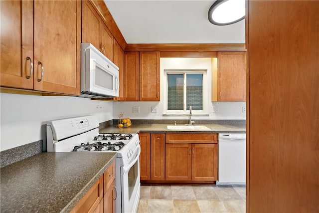 349 State Ave, Beaver, PA 15009 - kitchen featuring white appliances, a sink, brown cabinetry, and stone finish floors