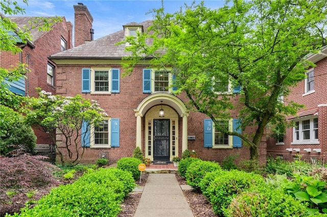 5810 Hampton St, Highland Park, PA 15206 - view of front of home with a chimney, a high end roof, and brick siding
