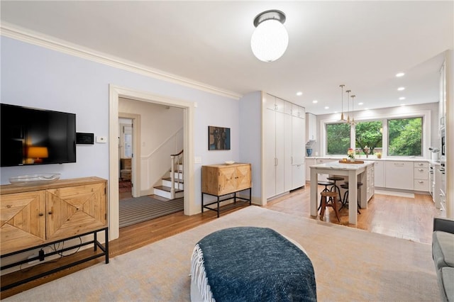 5810 Hampton St, Highland Park, PA 15206 - living room featuring light wood finished floors, stairway, ornamental molding, and recessed lighting