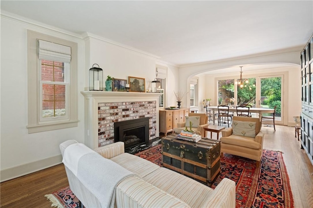 5810 Hampton St, Highland Park, PA 15206 - living room with wood finished floors, a chandelier, arched walkways, plenty of natural light, and ornamental molding