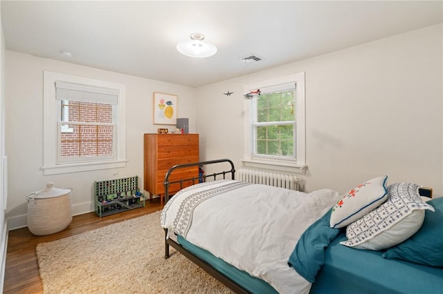 5810 Hampton St, Highland Park, PA 15206 - bedroom with radiator heating unit, wood finished floors, and baseboards