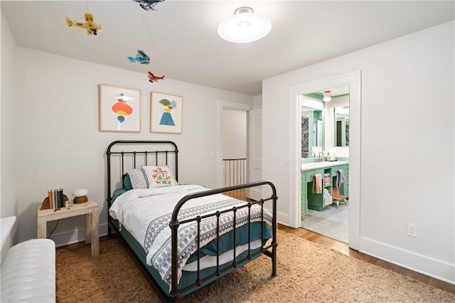 5810 Hampton St, Highland Park, PA 15206 - bedroom with wood finished floors, baseboards, and connected bathroom