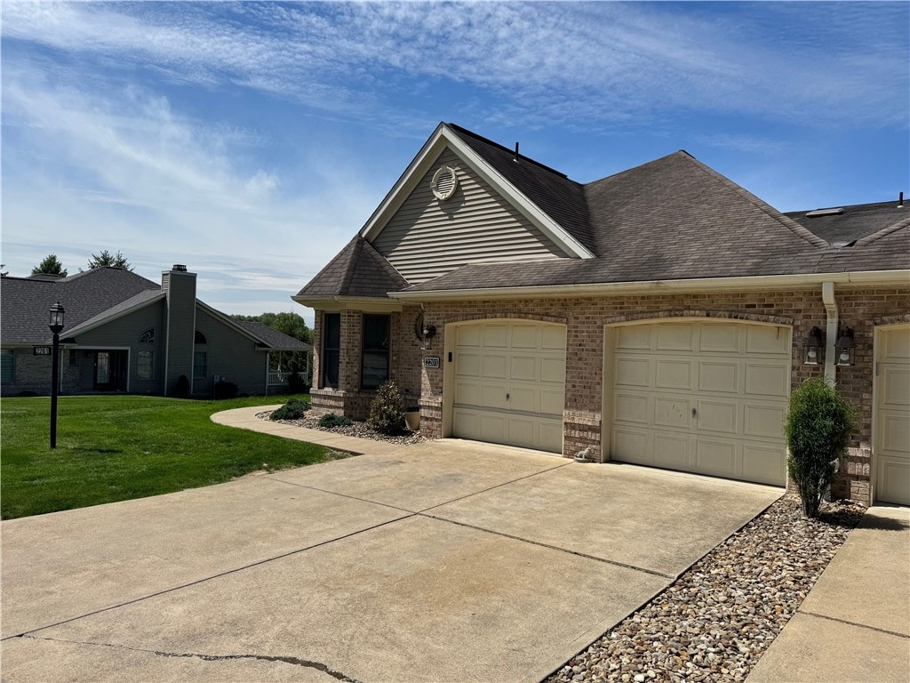 2201 Hunt Club Dr, Hempfield Twp Wml, PA 15601 - view of front of house with brick siding, an attached garage, concrete driveway, a front lawn, and roof with shingles