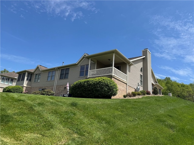 2201 Hunt Club Dr, Hempfield Twp Wml, PA 15601 - rear view of property with a chimney, a lawn, a balcony, and brick siding