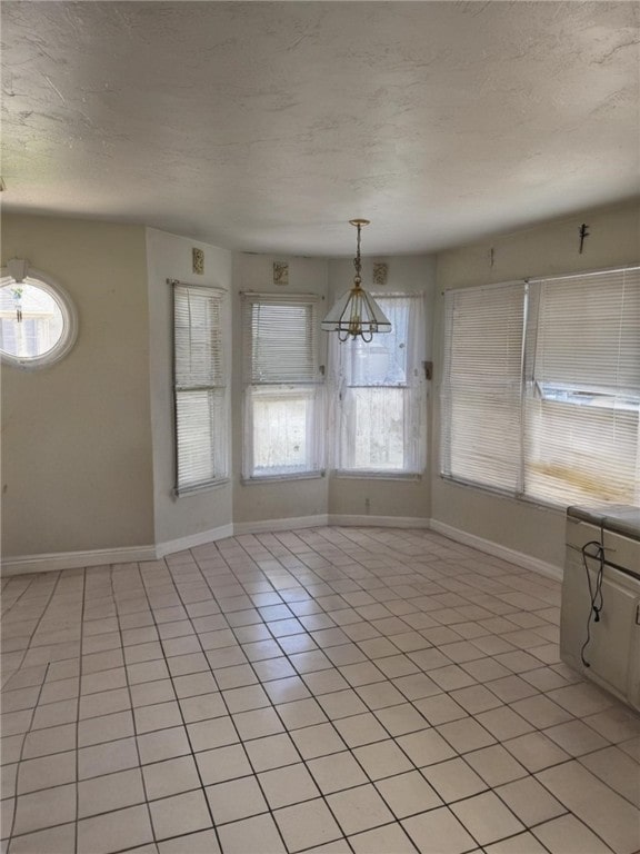 2201 Hunt Club Dr, Hempfield Twp Wml, PA 15601 - unfurnished dining area featuring a textured ceiling and light tile patterned floors