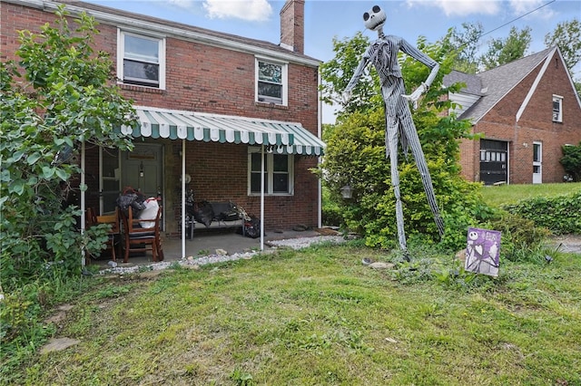 4218 Lebanon Church Rd, West Mifflin, PA 15122 - rear view of property featuring a chimney, a lawn, a patio area, and brick siding