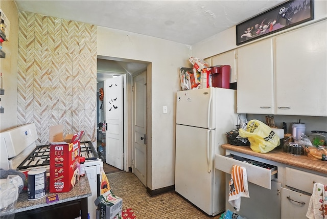 4218 Lebanon Church Rd, West Mifflin, PA 15122 - kitchen with freestanding refrigerator, white cabinetry, and baseboards
