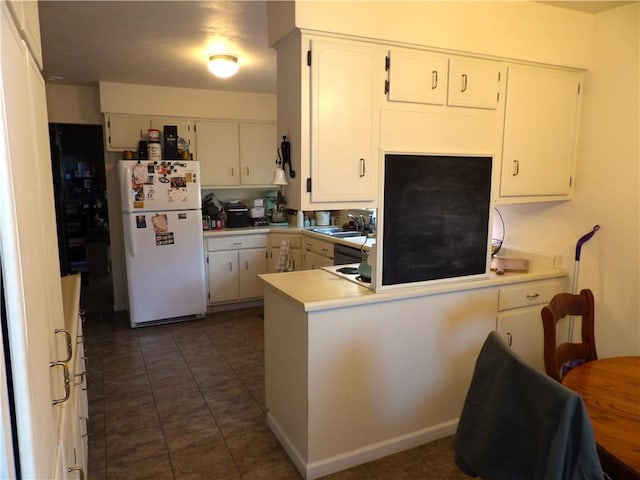 192 Searight Ave, Uniontown, PA 15401 - kitchen featuring freestanding refrigerator, a sink, a peninsula, and white cabinetry