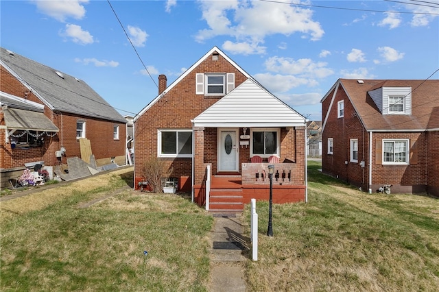 137 River View Blvd, Whitaker, PA 15120 - view of front of property with covered porch, brick siding, a front lawn, and a chimney
