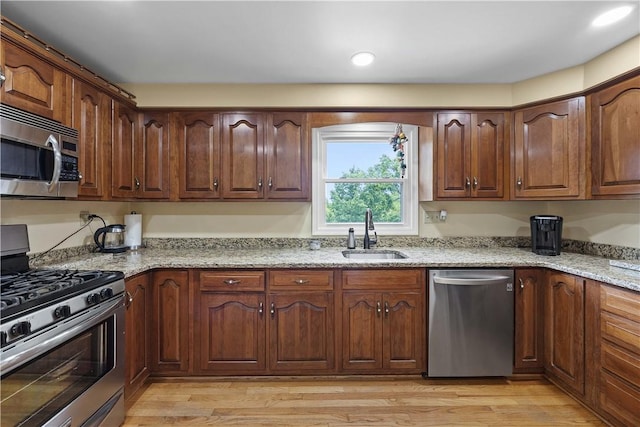 1209 Satellite Cir, Upper St Clair, PA 15241 - kitchen featuring appliances with stainless steel finishes, a sink, light stone countertops, light wood finished floors, and recessed lighting