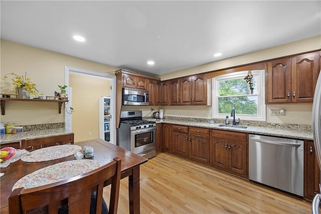 1209 Satellite Cir, Upper St Clair, PA 15241 - kitchen featuring stainless steel appliances, a sink, light wood-style flooring, light stone countertops, and recessed lighting