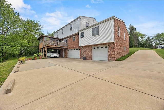 1209 Satellite Cir, Upper St Clair, PA 15241 - rear view of property featuring brick siding, concrete driveway, an attached garage, and a deck