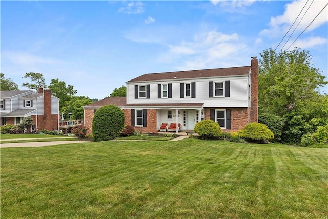 1209 Satellite Cir, Upper St Clair, PA 15241 - view of front facade with a porch, brick siding, a chimney, and a front lawn