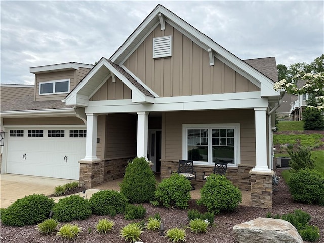 111 Sterling Oaks Dr, Level Green, PA 15085 - craftsman-style house with a porch, board and batten siding, stone siding, and driveway