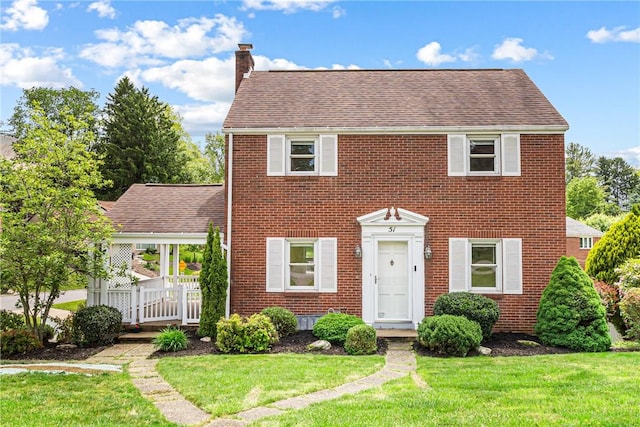 51 Hollow Haven Dr, Baldwin Boro, PA 15236 - colonial-style house featuring a chimney, brick siding, a front yard, and a shingled roof