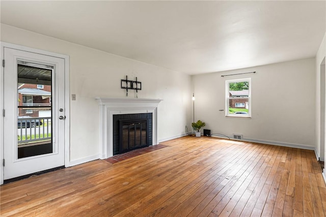 51 Hollow Haven Dr, Baldwin Boro, PA 15236 - unfurnished living room featuring light wood-type flooring, a fireplace with flush hearth, and baseboards