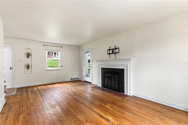 51 Hollow Haven Dr, Baldwin Boro, PA 15236 - unfurnished living room with hardwood / wood-style floors, a brick fireplace, and baseboards