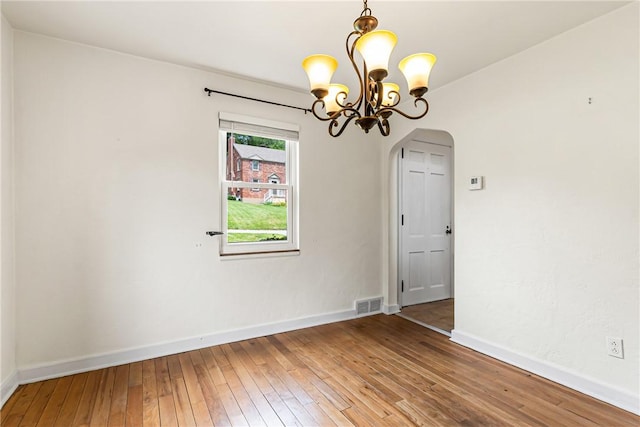 51 Hollow Haven Dr, Baldwin Boro, PA 15236 - empty room with arched walkways, a chandelier, hardwood / wood-style floors, and baseboards