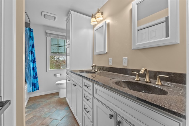 7104 Cresswyck Ct, Marshall, PA 15090 - full bathroom featuring double vanity, toilet, shower / bath combo with shower curtain, baseboards, and stone finish floors
