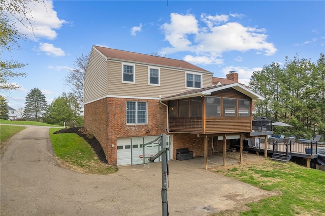 7104 Cresswyck Ct, Marshall, PA 15090 - rear view of property with a sunroom, brick siding, an attached garage, a chimney, and driveway