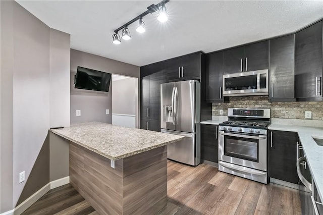 103 Cherokee Ct, Buffalo Twp But, PA 16229 - kitchen featuring stainless steel appliances, dark cabinetry, decorative backsplash, light wood-style floors, and baseboards