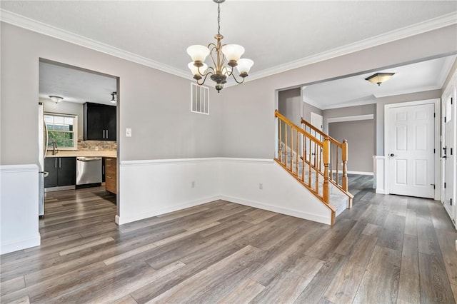 103 Cherokee Ct, Buffalo Twp But, PA 16229 - spare room with wood finished floors, stairway, a chandelier, crown molding, and baseboards