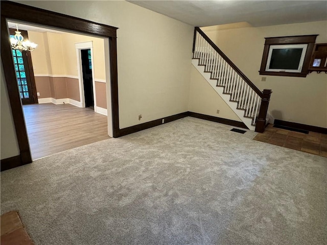 243 Oak St, City Of But Ne, PA 16001 - unfurnished living room with stairway, carpet floors, a chandelier, and baseboards