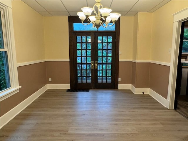 243 Oak St, City Of But Ne, PA 16001 - unfurnished dining area featuring a chandelier, wood finished floors, healthy amount of natural light, and a drop ceiling