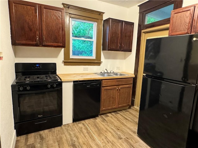 243 Oak St, City Of But Ne, PA 16001 - kitchen featuring black appliances, a sink, light wood finished floors, and plenty of natural light