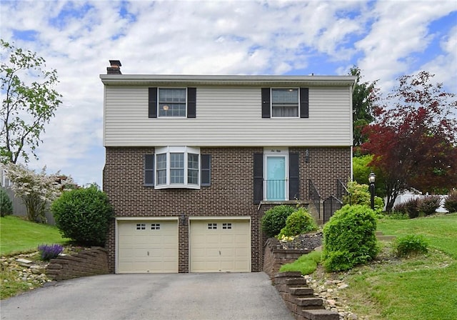 1050 Preston Dr N, Versailles, PA 15137 - colonial house featuring a chimney, brick siding, a garage, and asphalt driveway