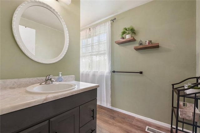1050 Preston Dr N, Versailles, PA 15137 - bathroom with vanity, wood finished floors, and baseboards