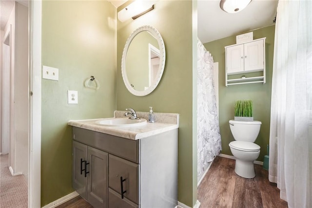 1050 Preston Dr N, Versailles, PA 15137 - bathroom featuring vanity, toilet, wood finished floors, and baseboards