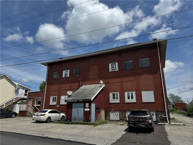 934 Wood St, Derry Twp, PA 15650 - view of front facade with brick siding and uncovered parking