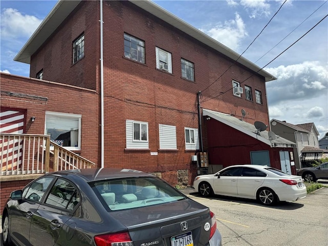 934 Wood St, Derry Twp, PA 15650 - view of side of property with brick siding and uncovered parking