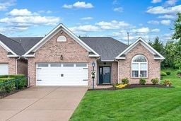 1011 Sunnyfield Ct, Penn Twp Wml, PA 15636 - view of front facade with a garage, a front yard, driveway, and brick siding