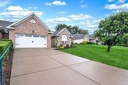 1011 Sunnyfield Ct, Penn Twp Wml, PA 15636 - ranch-style house with an attached garage, concrete driveway, and a front yard