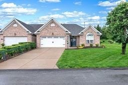 1011 Sunnyfield Ct, Penn Twp Wml, PA 15636 - view of front of property featuring a garage, a front lawn, and driveway
