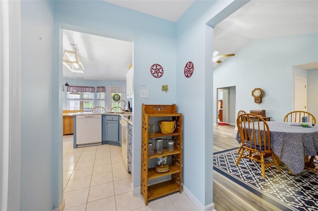 1011 Sunnyfield Ct, Penn Twp Wml, PA 15636 - kitchen with white dishwasher, lofted ceiling, light countertops, light tile patterned floors, and gray cabinets