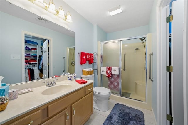 1011 Sunnyfield Ct, Penn Twp Wml, PA 15636 - bathroom featuring vanity, a shower stall, toilet, a walk in closet, and tile patterned floors