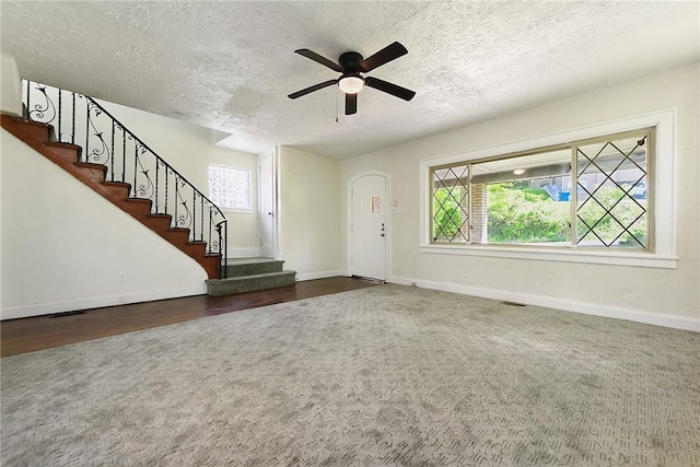 163 Universal Rd, Penn Hills, PA 15235 - carpeted foyer featuring a textured ceiling, baseboards, a ceiling fan, and stairs