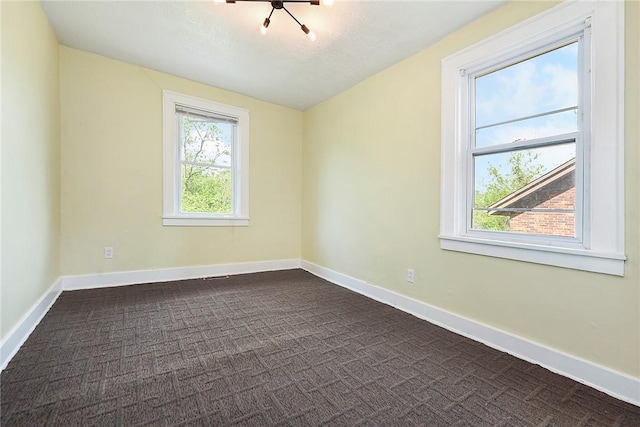163 Universal Rd, Penn Hills, PA 15235 - spare room with dark colored carpet and baseboards