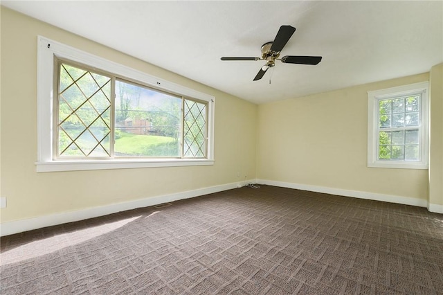 163 Universal Rd, Penn Hills, PA 15235 - empty room with healthy amount of natural light, dark carpet, baseboards, and a ceiling fan