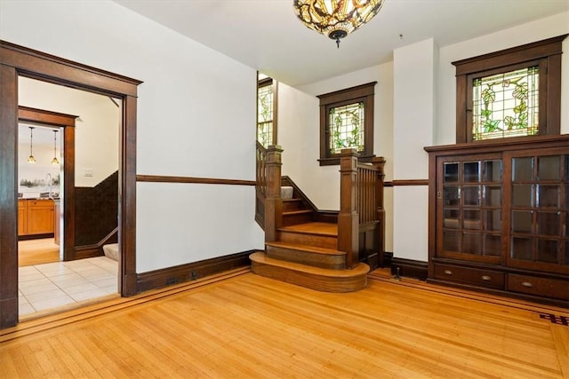 3319 Beechwood Blvd, Squirrel Hill, PA 15217 - empty room with plenty of natural light, wood finished floors, stairs, and baseboards
