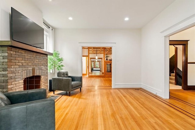 3319 Beechwood Blvd, Squirrel Hill, PA 15217 - living area featuring light wood finished floors, a brick fireplace, stairway, recessed lighting, and baseboards