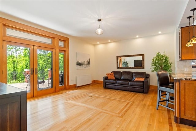 3319 Beechwood Blvd, Squirrel Hill, PA 15217 - living room featuring radiator, french doors, light wood-style floors, baseboards, and recessed lighting
