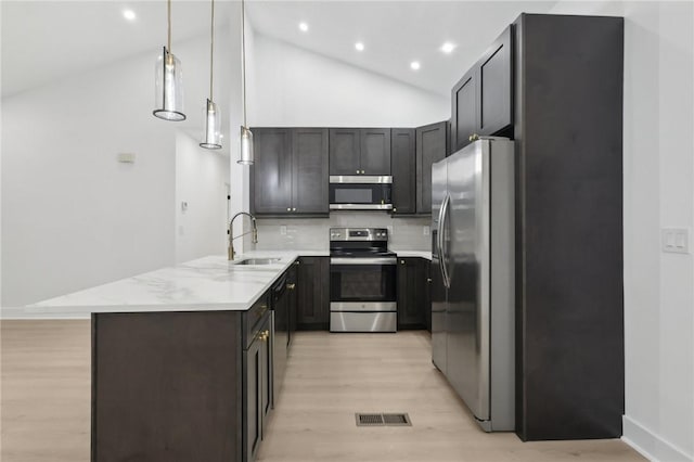 219 Randy Ln, Moon/Crescent Twp, PA 15108 - kitchen featuring appliances with stainless steel finishes, a sink, a peninsula, light wood-type flooring, and backsplash