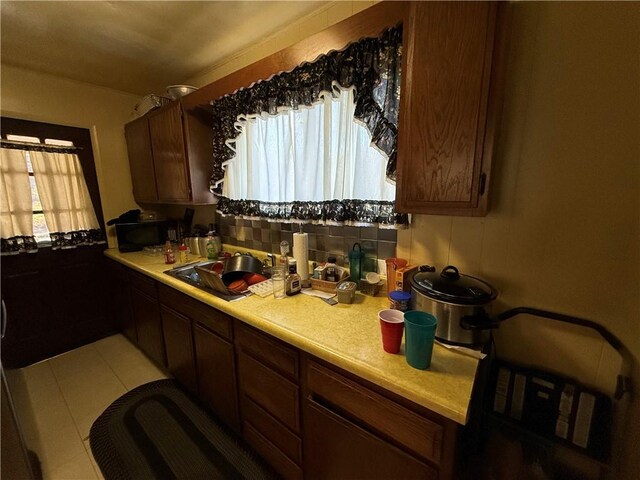 7134 Gladefield St, Lincoln-Larimer, PA 15206 - kitchen featuring light countertops, black microwave, a sink, and light tile patterned floors