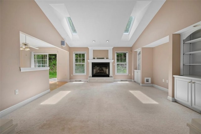 10276 Rinaman Rd, Mccandless, PA 15090 - unfurnished living room featuring a skylight, high vaulted ceiling, light carpet, baseboards, and a fireplace
